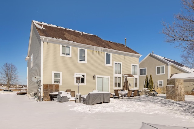 view of snow covered rear of property