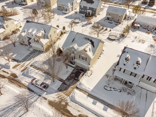 snowy aerial view with a residential view