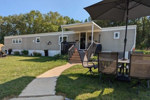 rear view of house with a yard