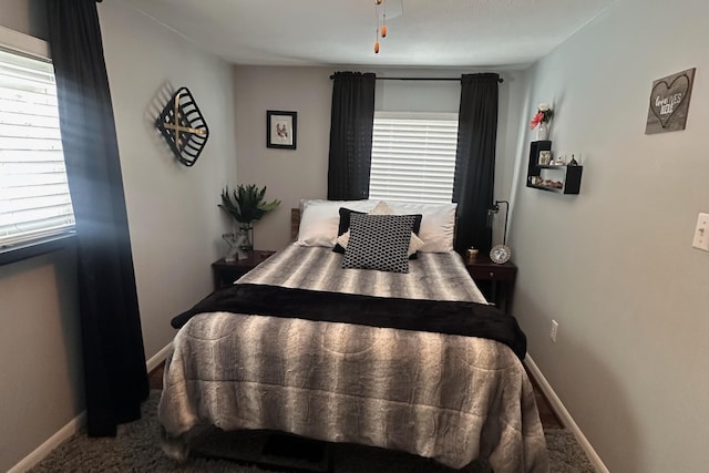 carpeted bedroom featuring baseboards