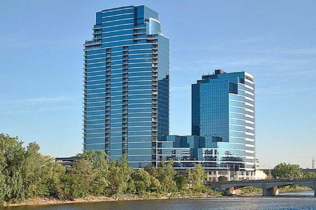 view of building exterior featuring a view of city and a water view