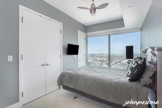 bedroom featuring a textured ceiling, a closet, carpet flooring, and a ceiling fan