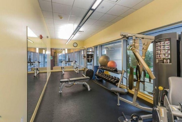 exercise room with a paneled ceiling