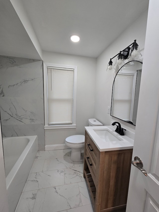 bathroom with toilet, a tub, marble finish floor, vanity, and recessed lighting