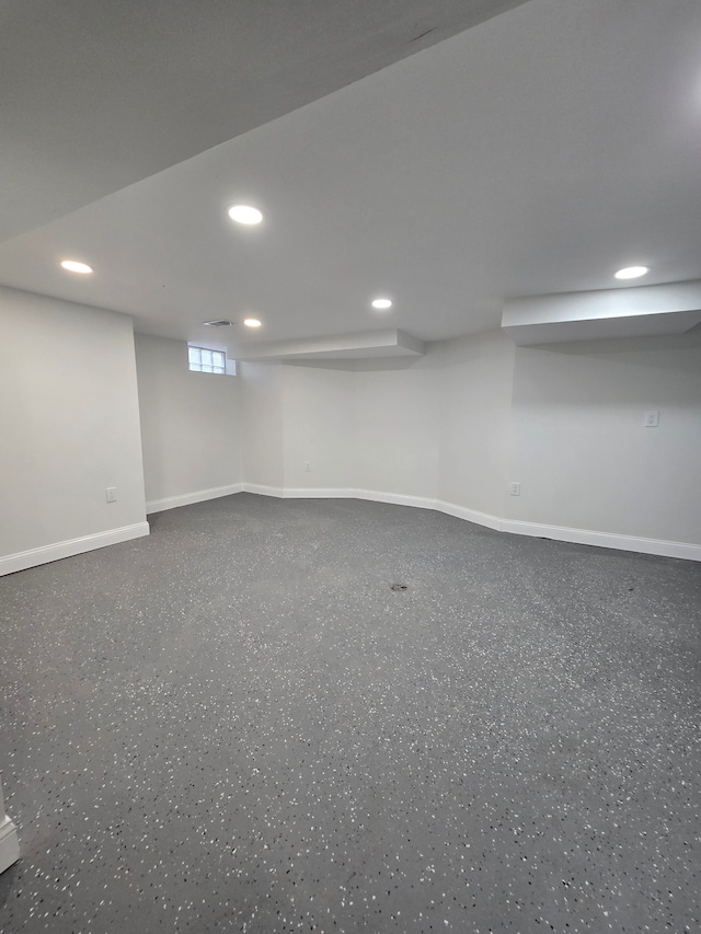 basement featuring recessed lighting and baseboards