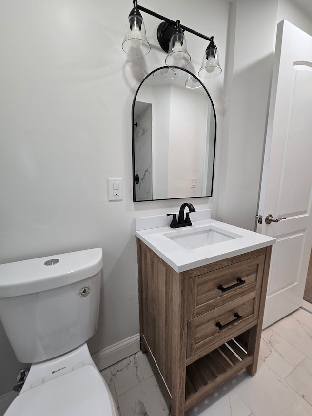 bathroom with marble finish floor, vanity, toilet, and baseboards