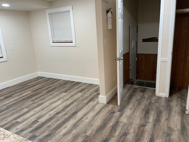 basement with dark wood-style flooring and baseboards