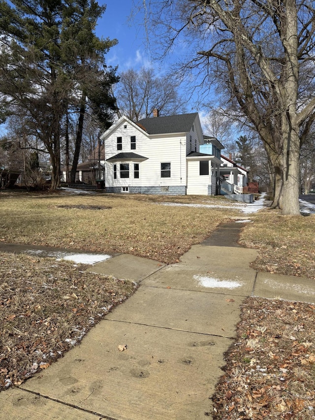 view of home's exterior featuring a yard and a chimney