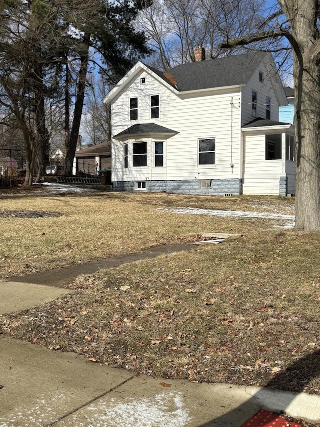 view of front of home with a chimney and roof with shingles