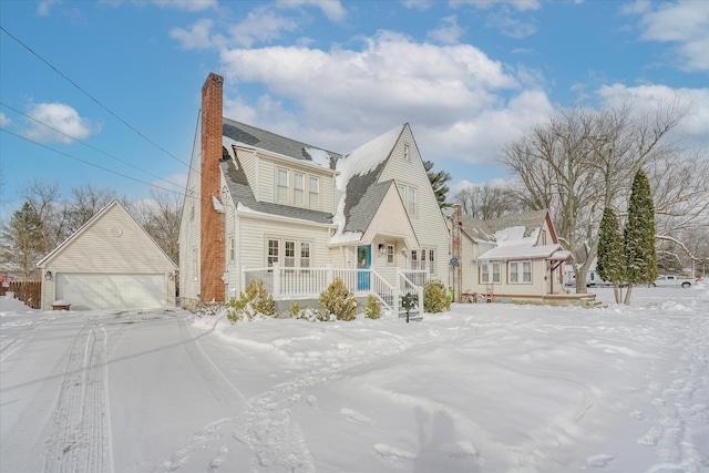 view of front facade featuring a garage and a chimney