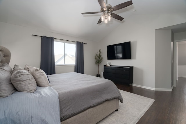 bedroom with dark wood-style floors, baseboards, vaulted ceiling, and a ceiling fan