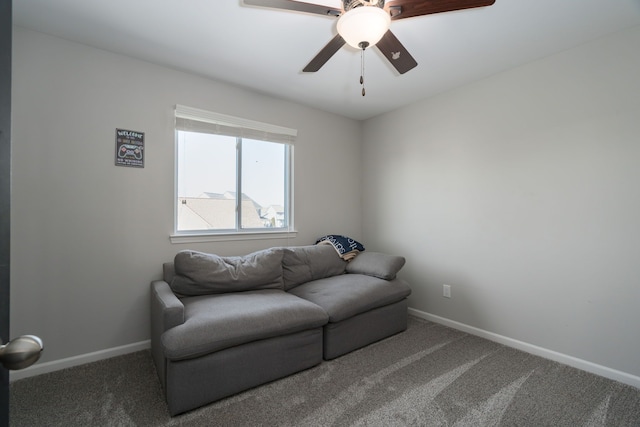 living area with carpet, a ceiling fan, and baseboards