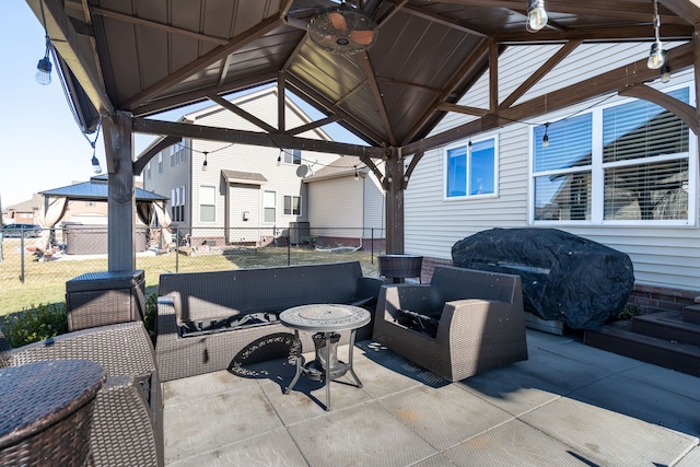 view of patio / terrace with a grill, fence, an outdoor living space, and a gazebo