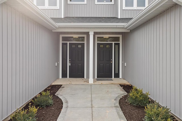 property entrance featuring roof with shingles