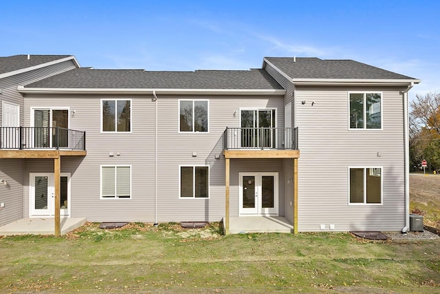 rear view of house with a yard, french doors, roof with shingles, and a patio area