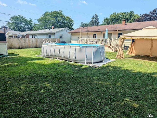 view of yard featuring a fenced in pool, fence, and a gazebo