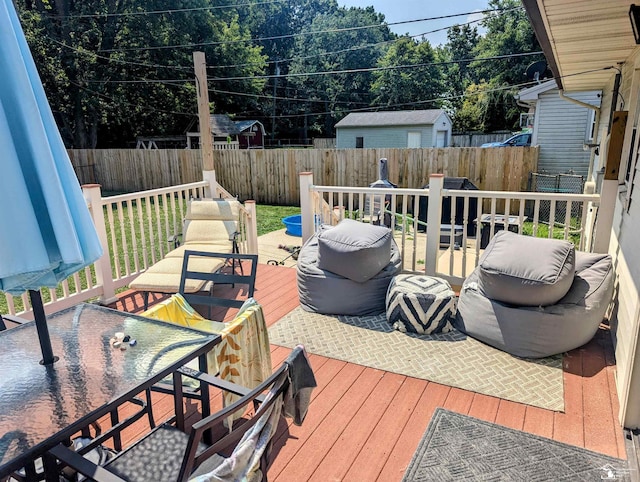 wooden terrace featuring a fenced backyard, a patio, and outdoor dining space