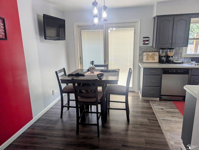 dining area featuring dark wood finished floors and baseboards