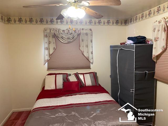 bedroom featuring a ceiling fan and baseboards