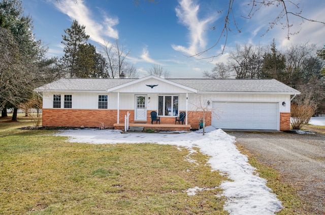 ranch-style house featuring an attached garage, brick siding, a shingled roof, driveway, and a front lawn