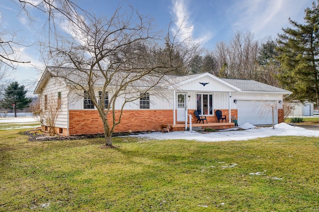 ranch-style home featuring a garage, a front yard, brick siding, and driveway