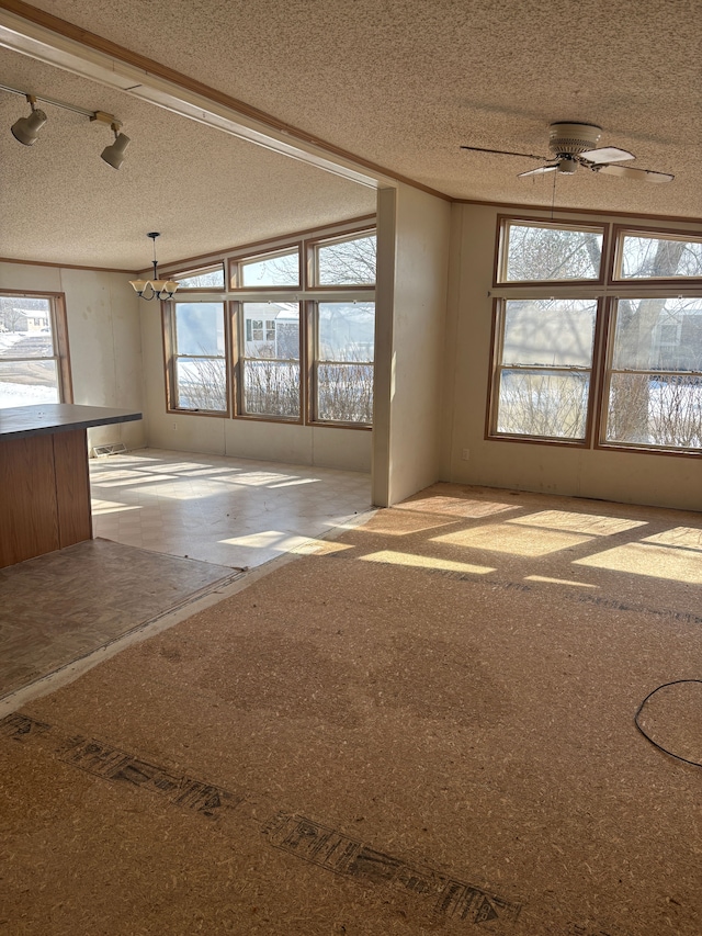 spare room with ceiling fan and a textured ceiling