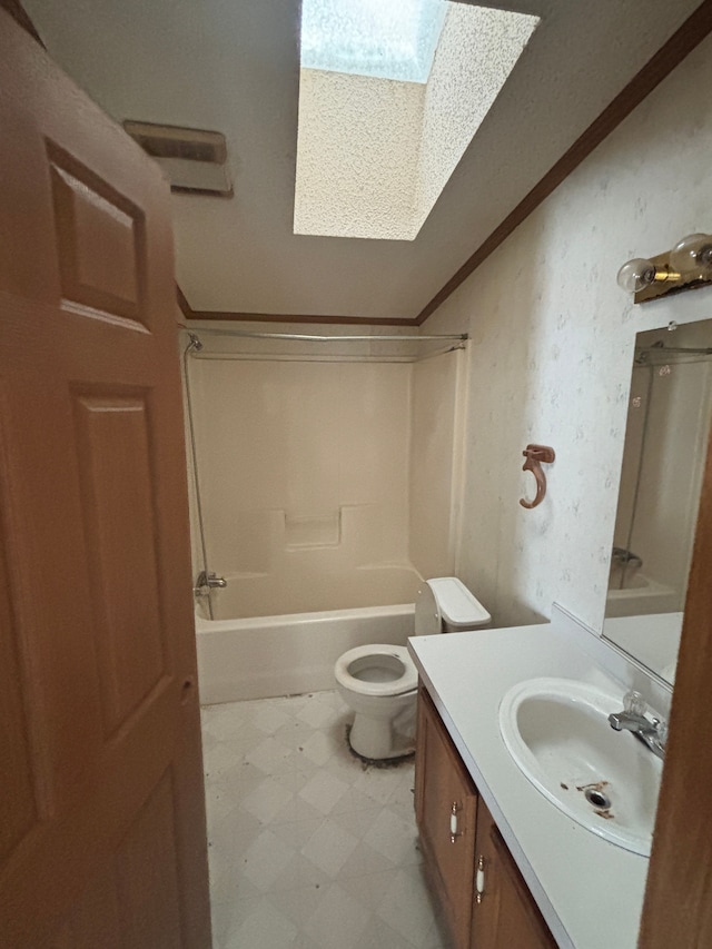 full bath featuring crown molding, toilet, washtub / shower combination, vanity, and tile patterned floors