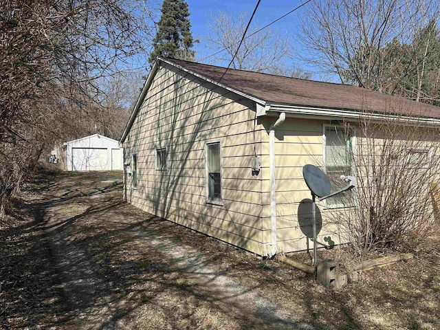 view of property exterior with an outbuilding