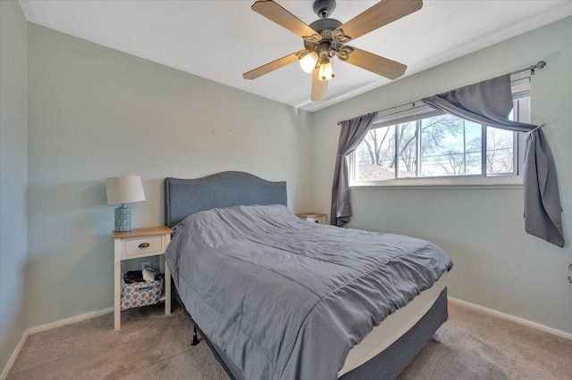 bedroom with light colored carpet, baseboards, and ceiling fan