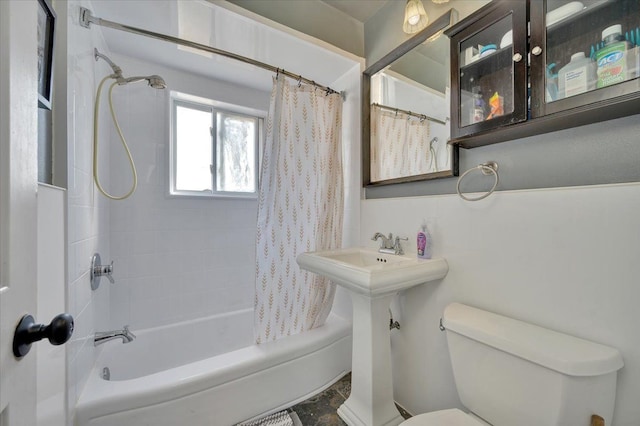 full bath featuring toilet and shower / tub combo with curtain