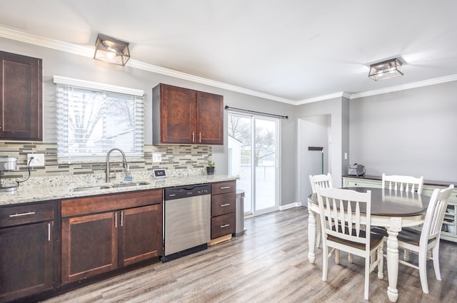 kitchen with light wood-type flooring, a sink, crown molding, decorative backsplash, and dishwasher