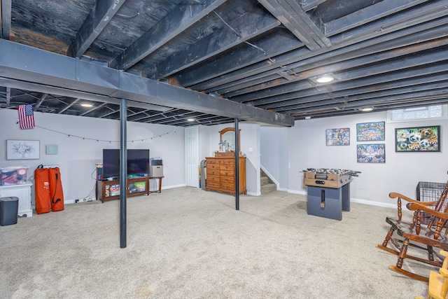 finished below grade area featuring stairs, carpet, and baseboards