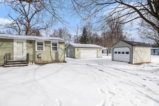 exterior space with a garage and an outbuilding