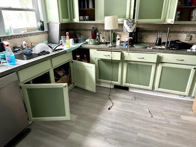 kitchen with a sink, green cabinets, open shelves, and stainless steel dishwasher