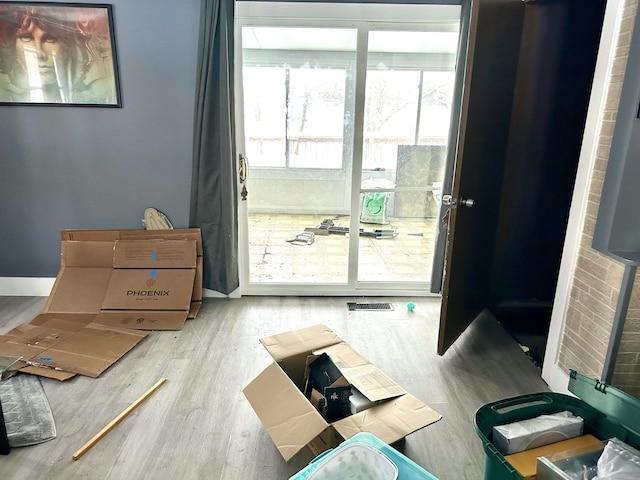 doorway to outside featuring wood finished floors and baseboards