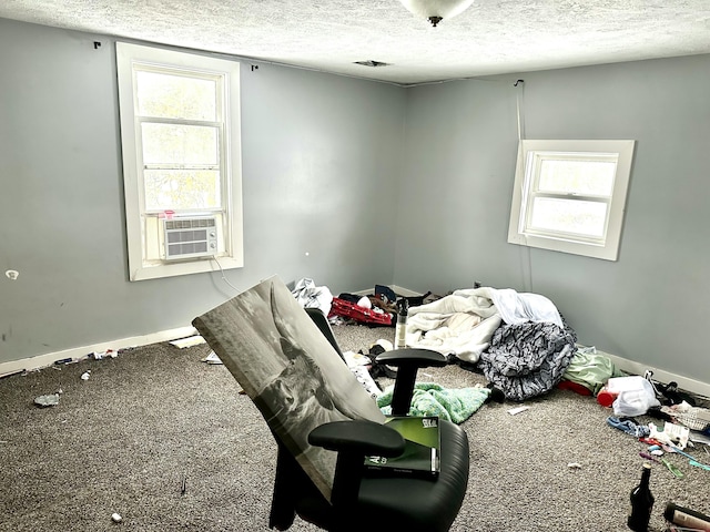 interior space featuring carpet flooring, a textured ceiling, and baseboards