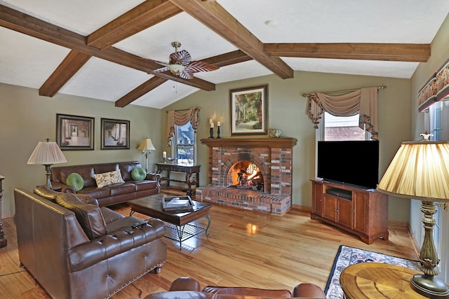 living area with a fireplace, light wood finished floors, lofted ceiling with beams, ceiling fan, and baseboards