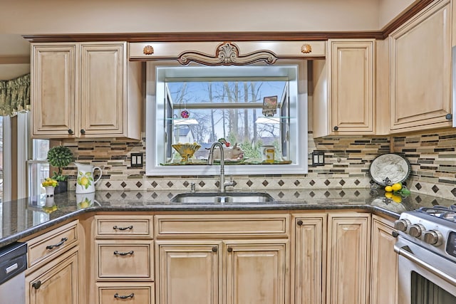 kitchen with appliances with stainless steel finishes, light brown cabinetry, a sink, and tasteful backsplash