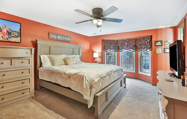 bedroom with ornamental molding, a ceiling fan, and light colored carpet