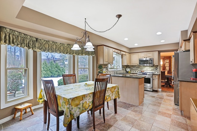 dining space with recessed lighting and baseboards