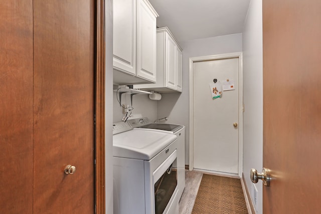 laundry room with washer and dryer and cabinet space