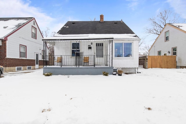 snow covered house with a chimney