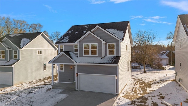 traditional home featuring driveway and an attached garage