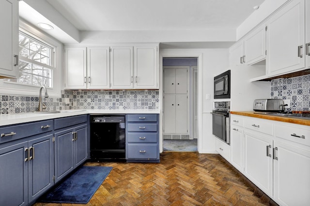 kitchen featuring black appliances, white cabinetry, and blue cabinetry