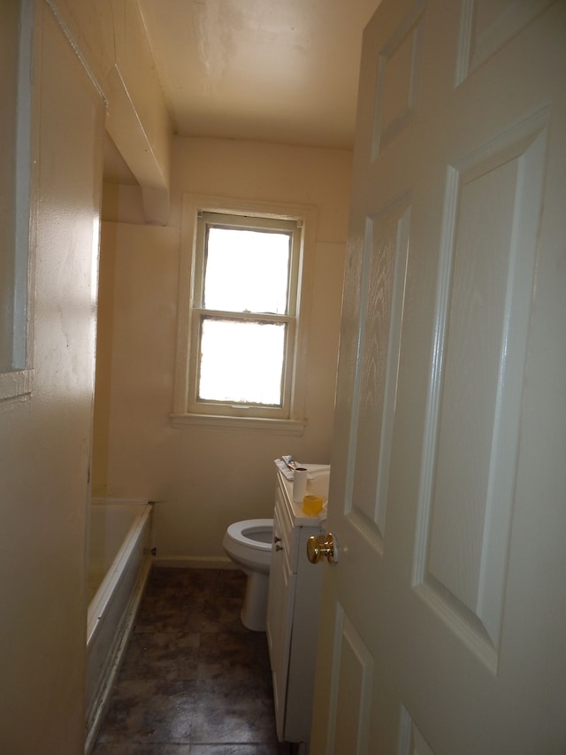 bathroom with baseboards, vanity, and toilet