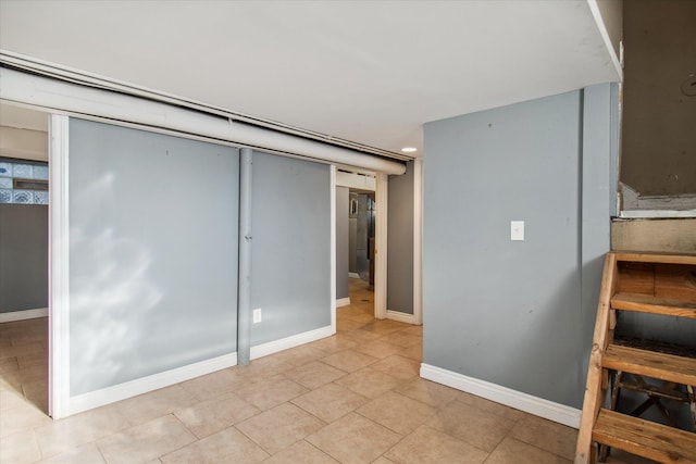 unfurnished bedroom featuring a closet and baseboards