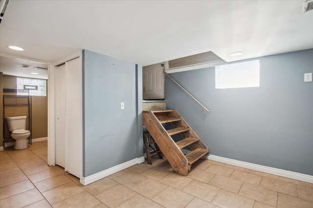 stairs with visible vents, baseboards, and tile patterned floors