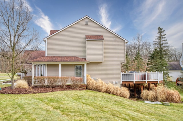 view of side of property featuring a deck and a yard