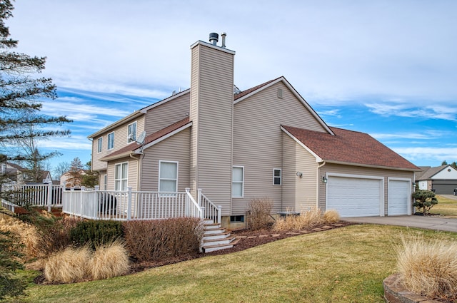 view of home's exterior featuring a yard, a chimney, an attached garage, a deck, and driveway