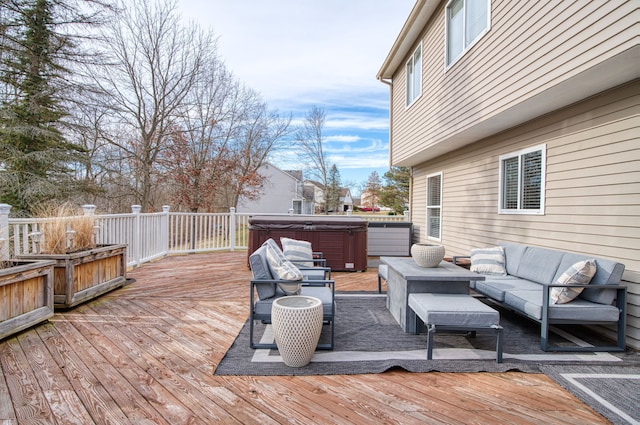 deck featuring a hot tub and an outdoor living space